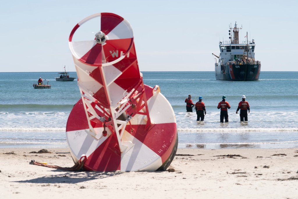 A large buoy that washed up on Wells Beach gets towed back to sea [Video]