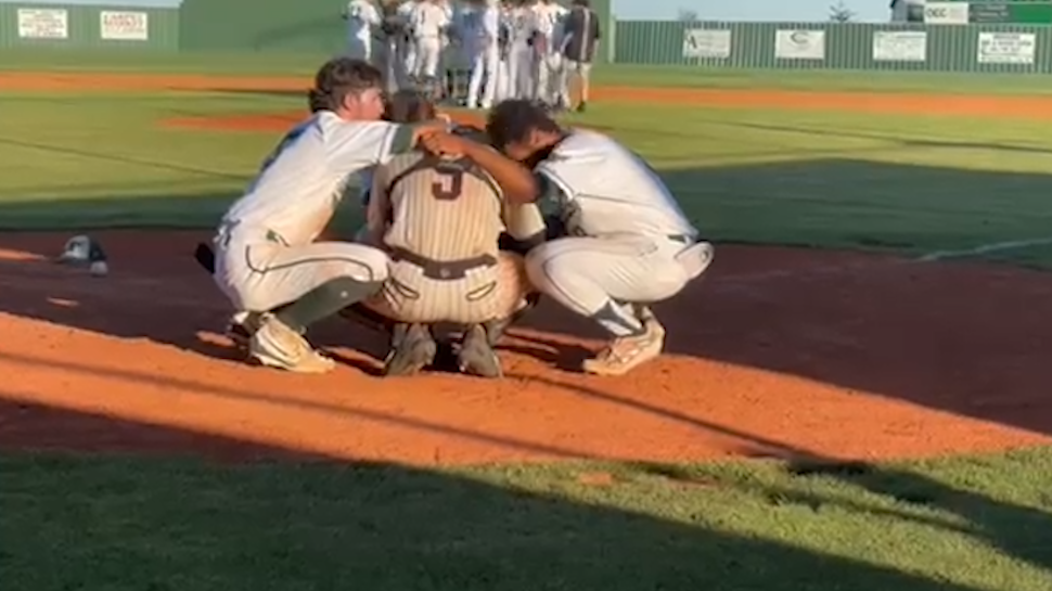 WATCH: High school baseball players embrace opposing catcher emotional after regional game [Video]