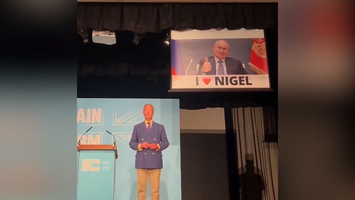 Watch: Activists interrupt Farages speech with huge Putin banner | News [Video]