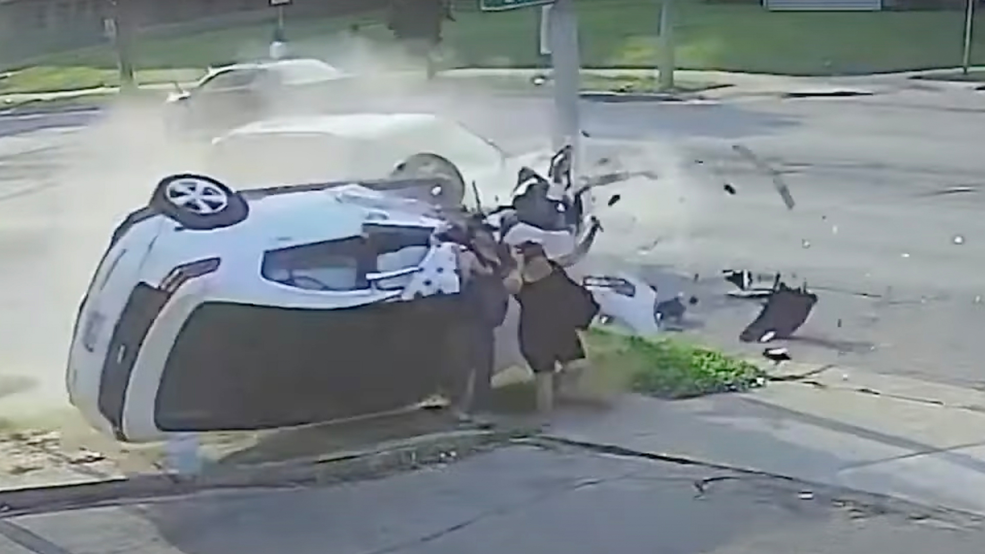 Heart-stopping moment out-of-control car barrels into couple on sidewalk – before unlikely item halts vehicle in instant [Video]